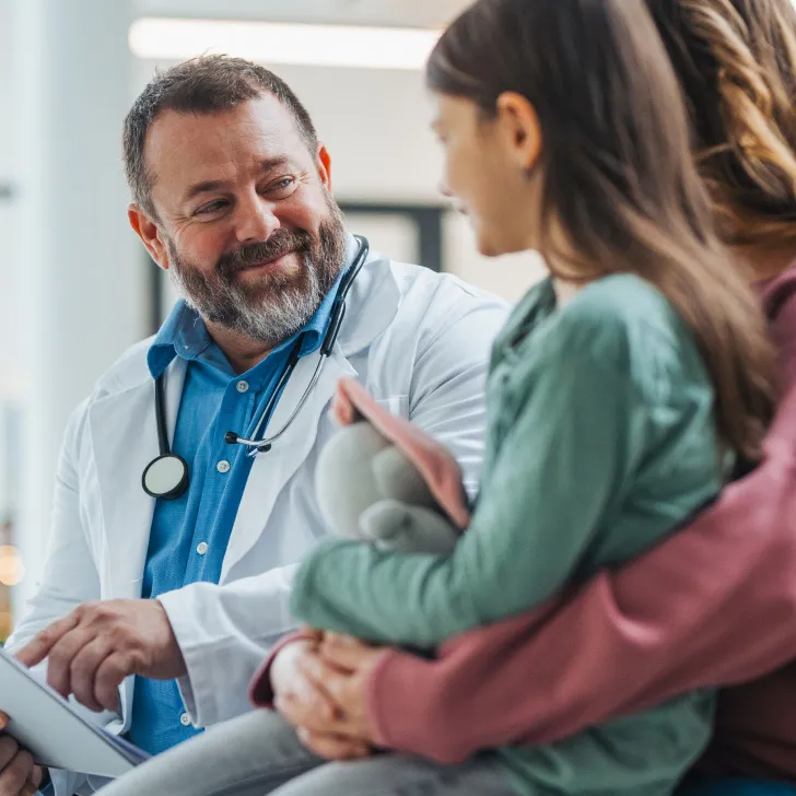 Pediatric IBD patient and parent talking with a provider