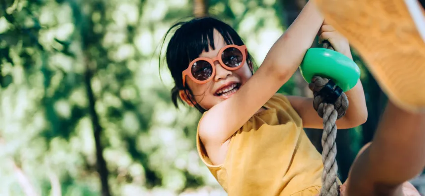 Pediatric Crohn's disease patient playing at a playground