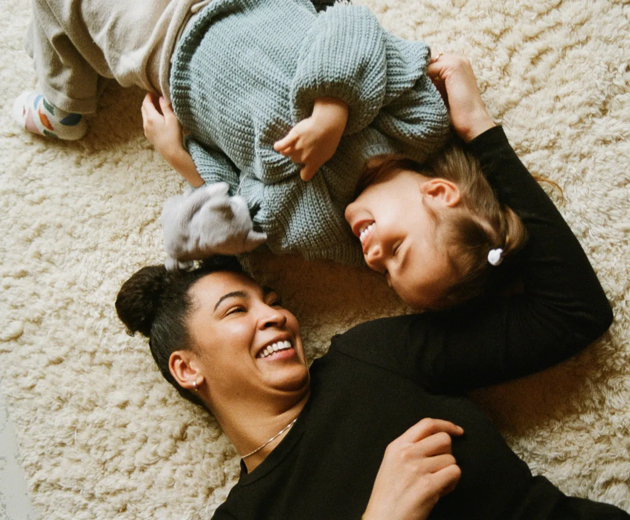 A parent comforting a child who has symptoms of IBD