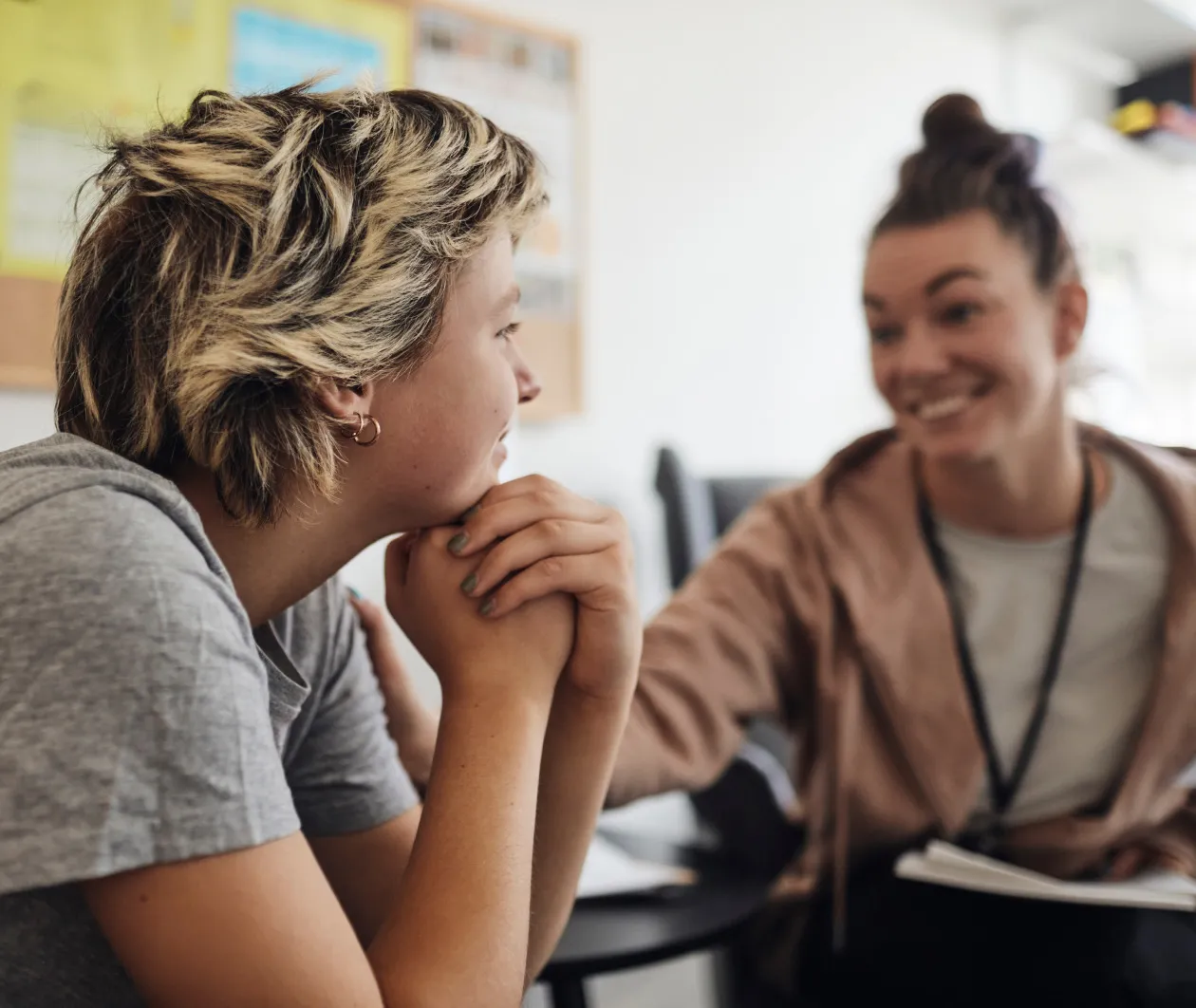Teen Crohn's disease patient talking with a friend