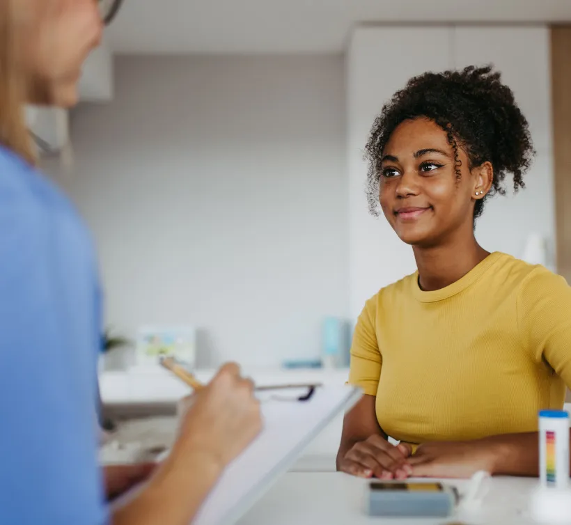 Teen IBD patient talking with a provider